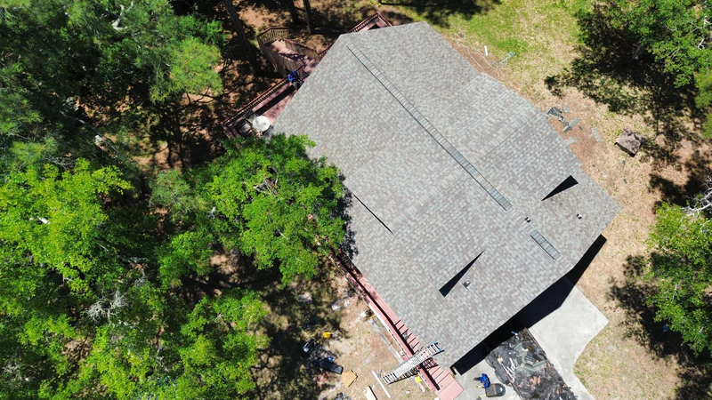 Aerial before-and-after of a full shingle roof replacement by JJ Roofing in the South Carolina Lowcountry