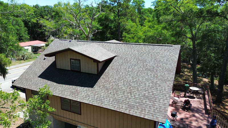Side-view before-and-after of a shingle roof installation by JJ Roofing