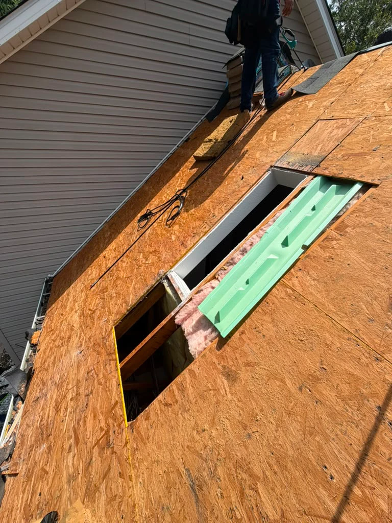 Roof decking repair with fresh plywood sheathing before re-roofing by JJ Roofing