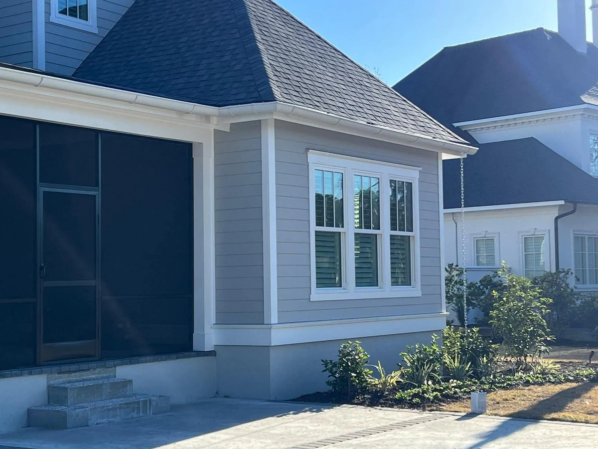 Wide elevation of new white seamless gutters installed along a Lowcountry home in Beaufort, South Carolina